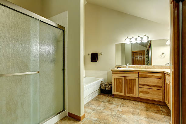 istock Elegant bathroom in soft tones with hardwood cabinets 576926982