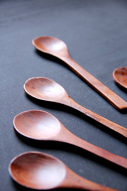 istock Wooden crafted spoon on black background 576927946