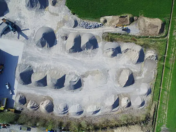Drone shot of grey stones in piles on building site