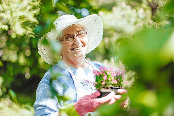 istock Smiling senior woman is gardening 576929120