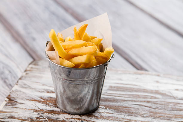 istock Yellow fries in small bucket. 576930968