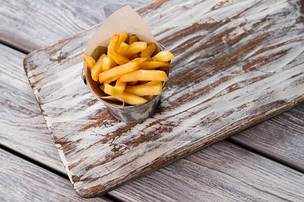 istock French fries in a bucket. 576931042
