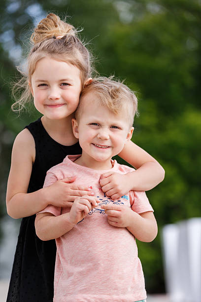 istock Brother playing with sister in the park 576932618