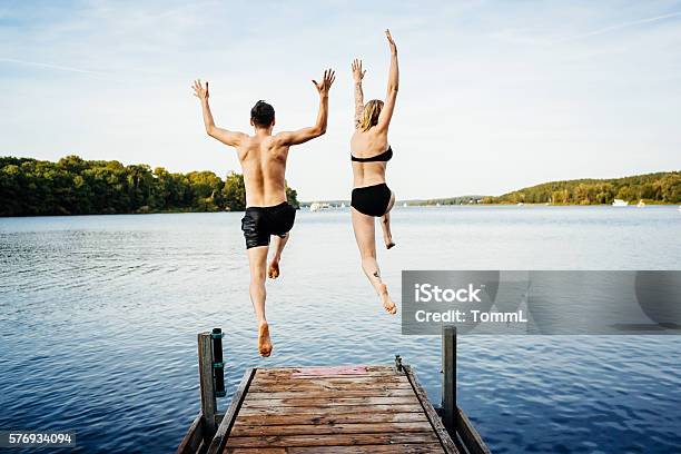 Jumping Into The Water From A Jetty Stock Photo - Download Image Now - Jumping, Lake, Swimming