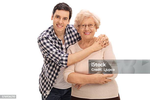 Young Man Hugging A Senior Lady Stock Photo - Download Image Now - Grandmother, Mother, Grandson