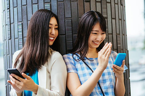 istock Girlfriends having fun with smart phones 576936762