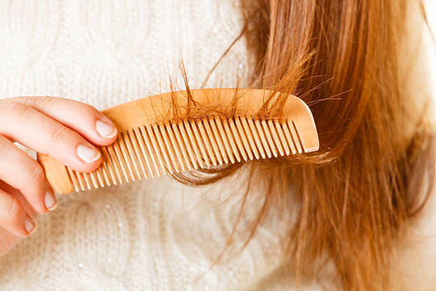 istock Female hand combing long hair. 576936818