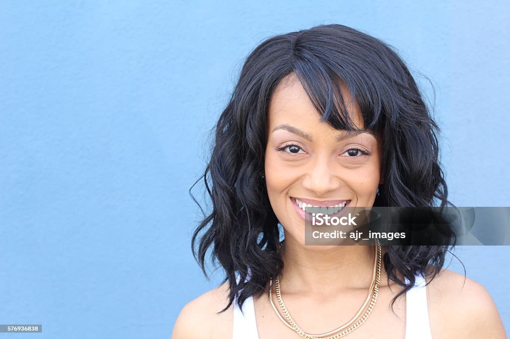 Laughing African American woman with an wavy hairstyle Laughing African American woman with an wavy hairstyle and good sense of humor smiling. Bangs - Hair Stock Photo