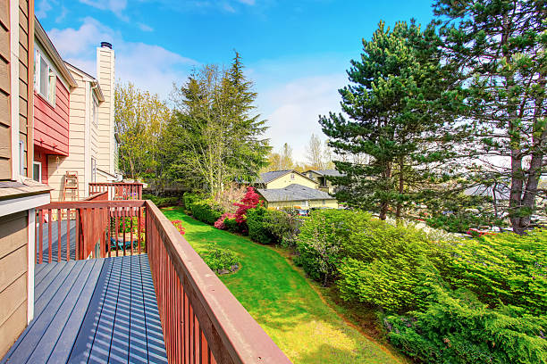 istock Small empty wooden porch with view of back yard 576936914