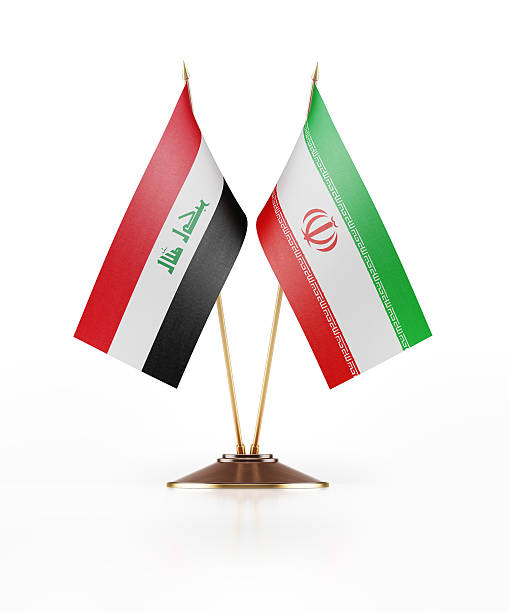 Miniature Flag of Iraq and Iran Miniature Flag of Iraq Iraq and Iran. Desk piece flag pair. The flag has nicely detailed fabric texture.  Isolated on white background. Clipping path is included. iraqi flag stock pictures, royalty-free photos & images