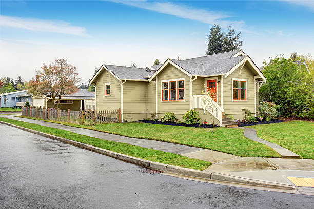 istock Old small green American home with porch. 576937812