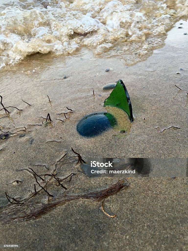 Broken bottle at the beach One broken bottle at the beach, very dangerous to go swimming Alcohol - Drink Stock Photo Broken bottle at the beach One broken bottle at the beach, very dangerous to go swimming Alcohol - Drink Stock Photo
