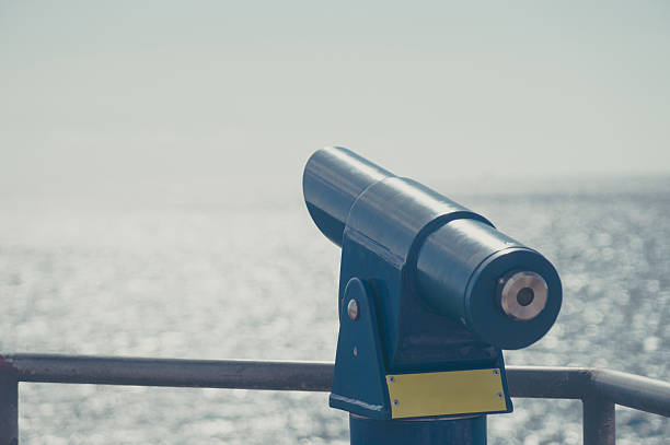 istock Tourist binoculars with ocean on background 576938316