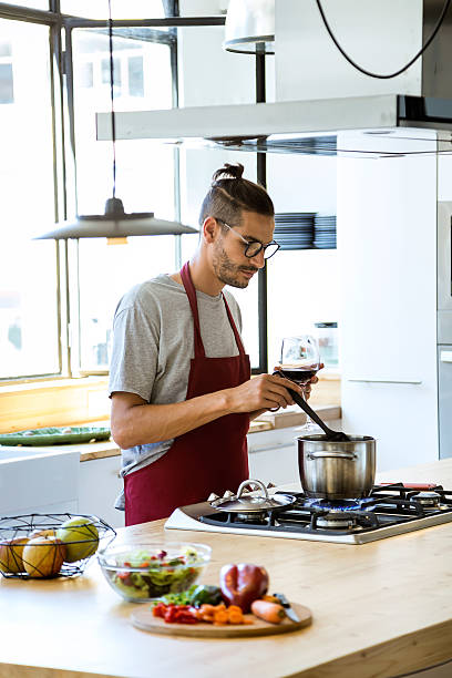 istock Handsome young man cooking in the kitchen at home. 576938516