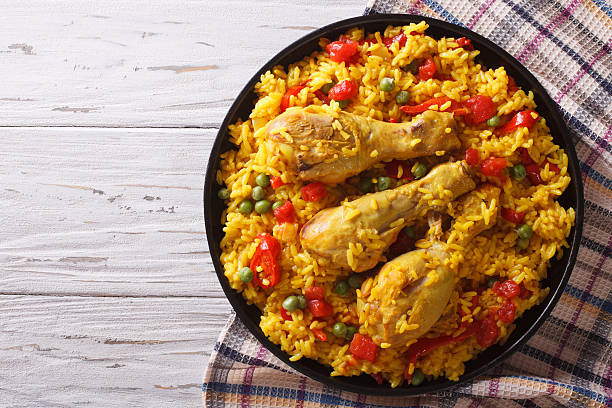 istock Spanish paella with chicken and vegetables. horizontal top view 577302706