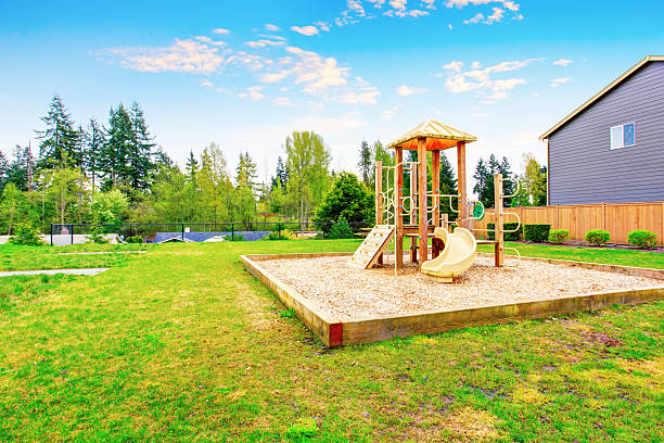 istock Backyard with play set for kids with swings and slides 577303034