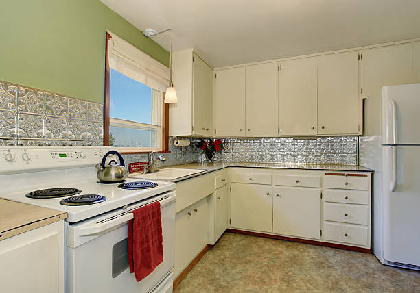 istock Antique kitchen interior with white cabinets and green wall. 577304334