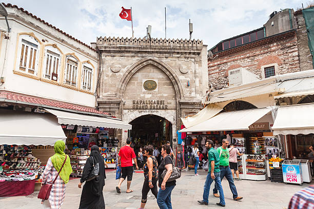 Istanbul streetview, Grand Bazaar entrance Istanbul, Turkey - June 28, 2016: Ordinary people walk on the street in old central district of Istanbul city near Grand Bazaar entrance grand bazaar istanbul stock pictures, royalty-free photos & images