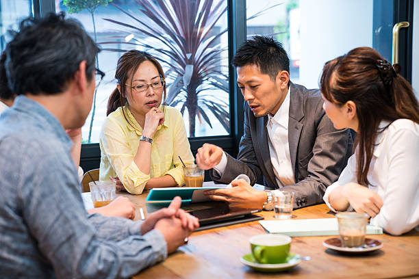 istock Casual business meeting in cafe with a large digital tablet 577305626
