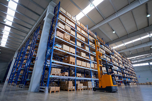 istock Forklift Lifting a cardboard box in warehouse aisle 577306172