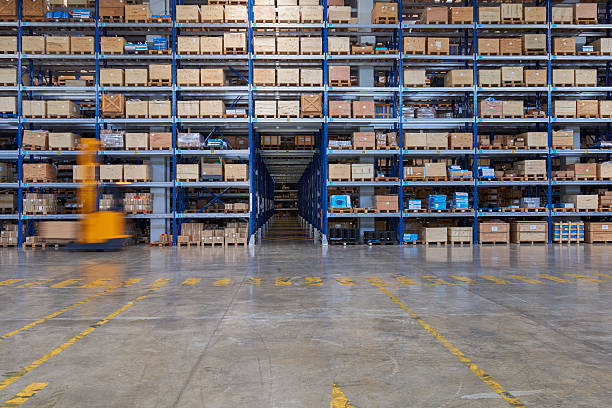 istock Forklifts lifting cardboard box in warehouse. 577306198