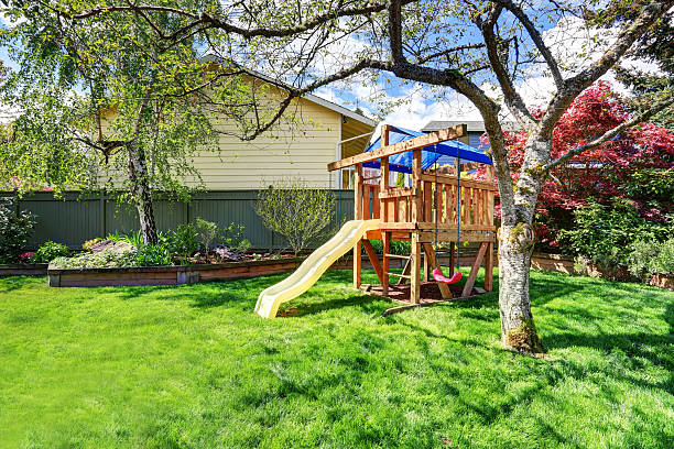 istock View of kids playground in backyard garden with birch trees 577307036