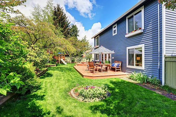 istock Wooden walkout deck in the backyard garden 577307332