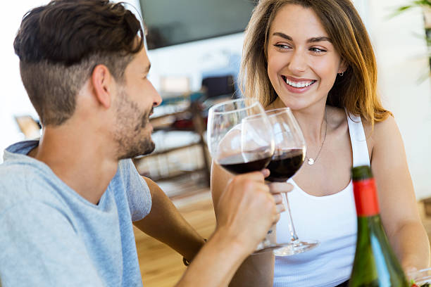 istock Happy couple dining and drink wine at home. 577307554