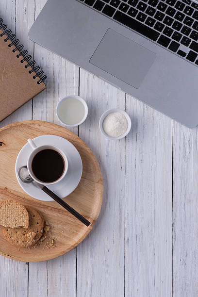 istock Cup of coffee on a white wooden 577308064