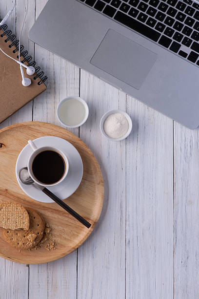istock Cup of coffee on a white wooden 577308126