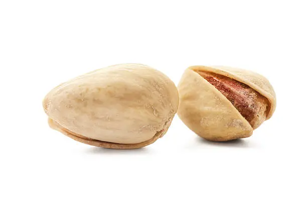 Photo of Toasted pistachios on white background