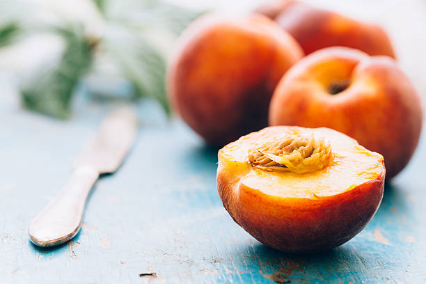 istock peaches on blue the texture wooden background 577308574