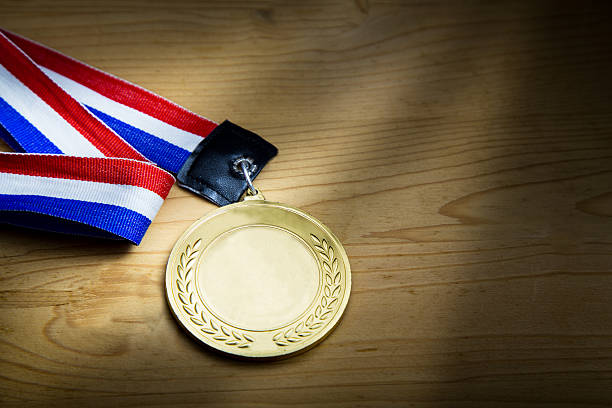 istock Generic sporting event gold medal with red and blue ribbon 577309090