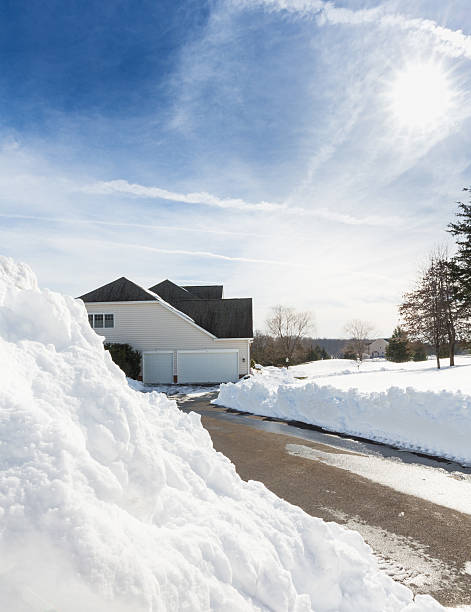 istock Deep drifts by side of driveway to modern home 577309252