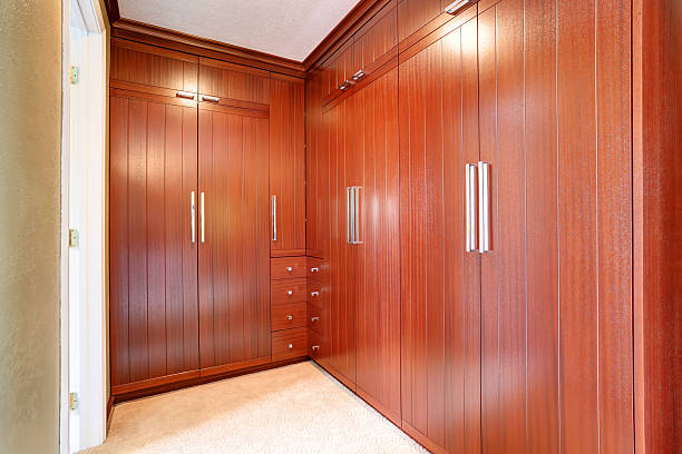 istock Luxury wardrobe room with brown modern built-in cabinets 577309268