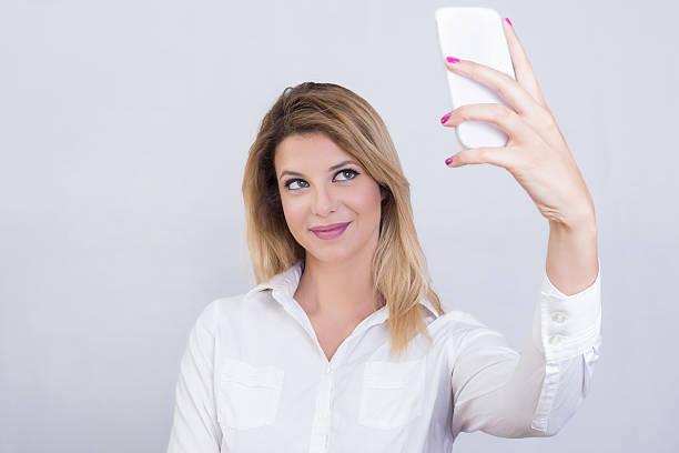 istock Blonde girl taking a selfie 577309796