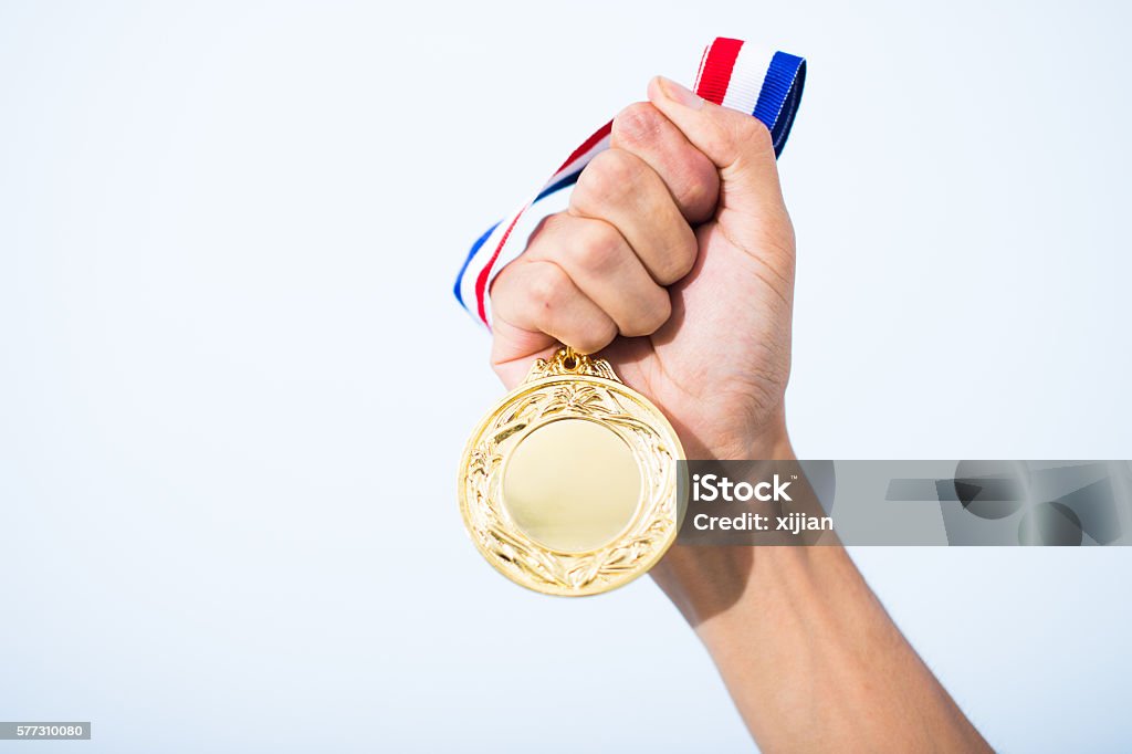 hand holding gold medal Medal Stock Photo