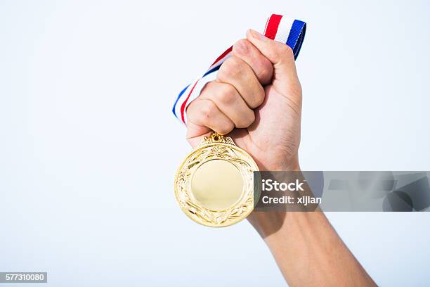 Hand Holding Gold Medal Stock Photo - Download Image Now - Medal, Badge, Trophy - Award