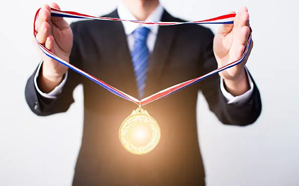 Photo of Businessman giving gold medal
