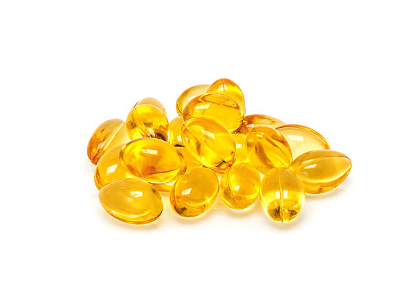 istock Fish oil capsules isolated on white background 577311344