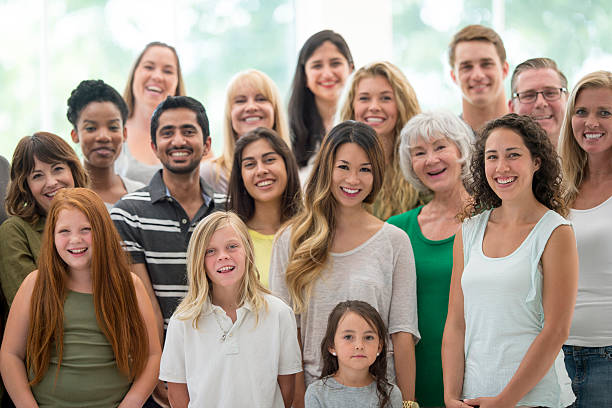 Mix of Cultural Heritage A multi-ethnic group of three generations of family members are standing together during a family reunion. canadian culture photos stock pictures, royalty-free photos & images