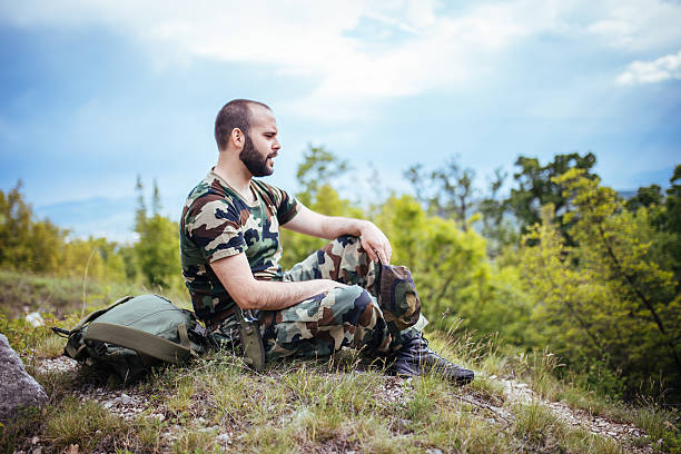 istock Young soldier sitting on the ground 577316314