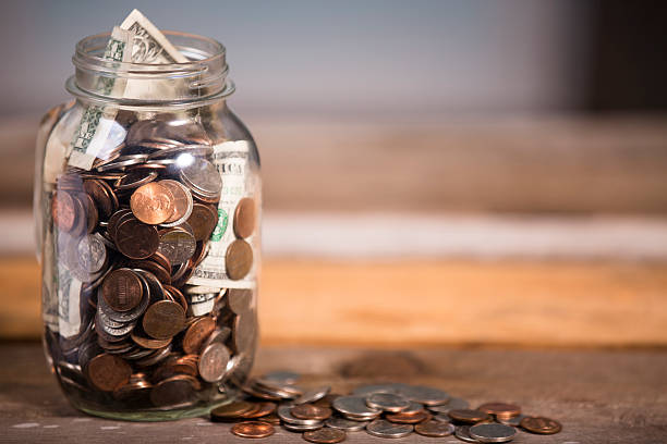 istock Money jar with U.S. currency.  Savings, donations concepts. 577316330