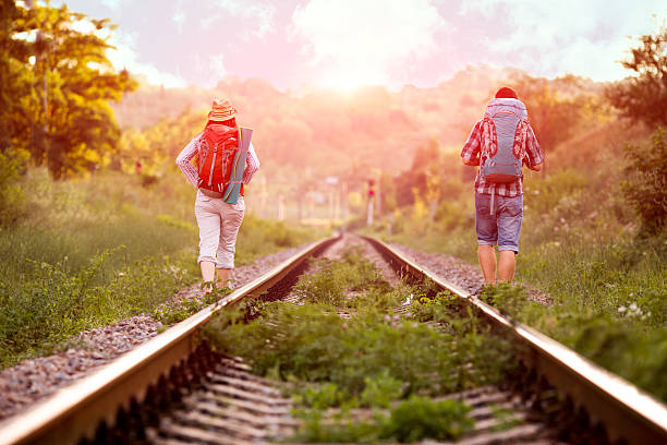 istock Two young Hikers walking along old Country Railroad 577316936