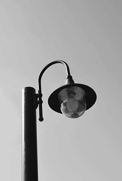 istock Lamp post against  sky - black and white tone 577319002