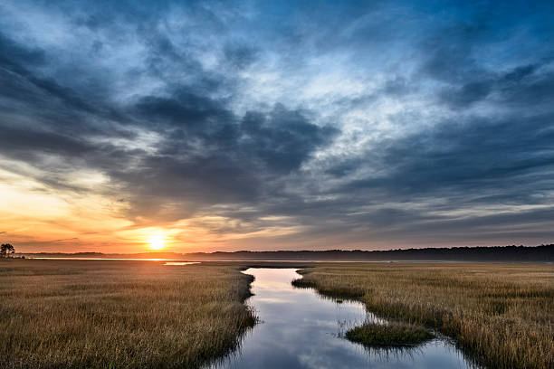istock Beautiful Sunrise Along Coastal Inlet with Dramatic Clouds 577319620
