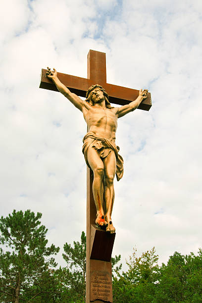istock Christ on cross in middle of forest 577319908