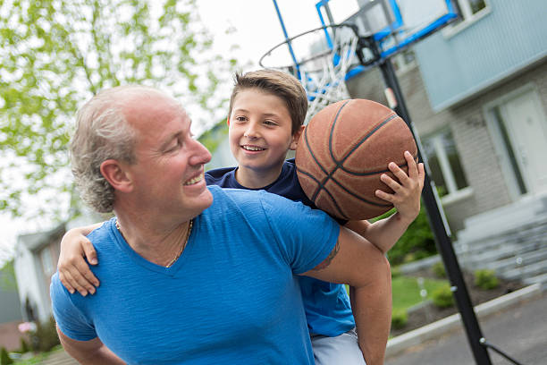 istock Image of young man and his son playing basketball 577321374