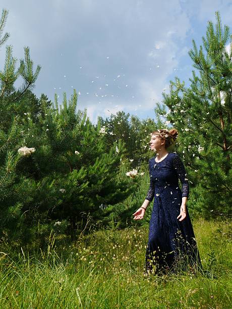istock fairy like woman in evening gawn throughs feathers 577321758