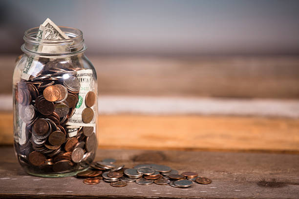 istock Money jar with U.S. currency.  Savings, donations concepts. 577322170